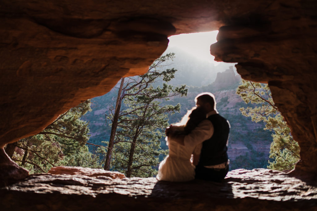 A couple watching the sunset during a sedona elopement hike