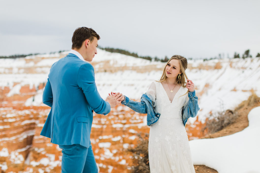 A couple stands at the edge of the amphitheater at Bryce Canyon National Park during their winter elopement.