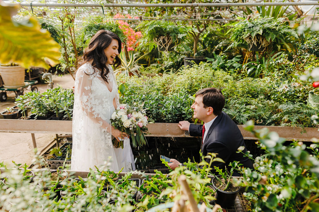 A couple sharing elopement vows in a tropical greenhouse