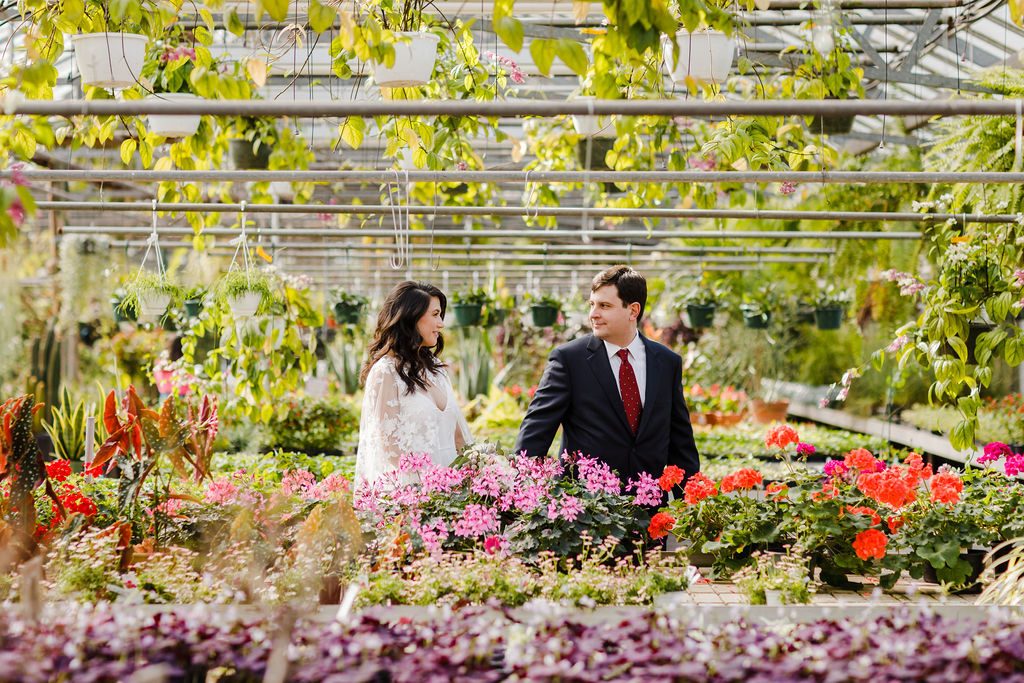 Wedding couple walking through a tropical greenhouse